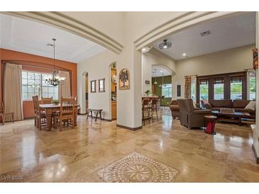 Spacious open-concept living room featuring a dining area, tile floors, and abundant natural light at 36 Avenida Fiori, Henderson, NV 89011
