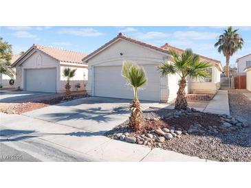 House exterior featuring a two-car garage and desert landscaping at 4634 Skybolt St, Las Vegas, NV 89115