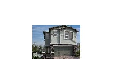 Two-story home with gray siding, stone accents, and a two-car garage at 575 Preston Oak, Las Vegas, NV 89138