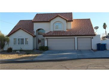 Two-story house with three-car garage and terracotta roof at 6701 Willow River Ct, Las Vegas, NV 89108