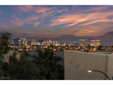 Striking panoramic view of the city skyline and distant mountains under a vibrant sky at sunset at 9331 Hilgard Ave, Las Vegas, NV 89178