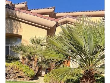 Spanish style home exterior with lush landscaping and a terracotta roof at 10 Dry Brook Trl, Henderson, NV 89052