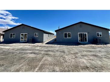 Charming single-story duplex featuring matching units and a spacious parking area at 1881 Big Horn St, Pahrump, NV 89048