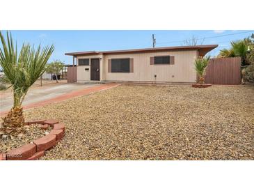 Modest single story home featuring low maintenance landscaping and a neutral exterior paint scheme at 111 Manganese St, Henderson, NV 89015