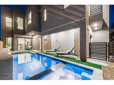 Luxury pool and spa with lounge chairs, perfect for relaxing evenings at 2824 Queens Courtyard Dr, Las Vegas, NV 89109