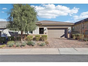 Single-story home with attractive landscaping and a brick paved driveway at 335 Alto Avec Ln, Henderson, NV 89011