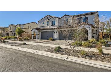 Two-story house with gray garage doors and a landscaped front yard at 340 Silva Pl, Henderson, NV 89011