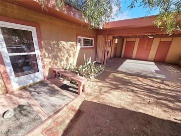 Desert landscape surrounds this single-story home with carport and gated entry at 71 E Atlantic Ave, Henderson, NV 89015