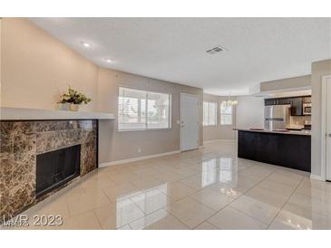 Bright living room features a fireplace and tile floors at 916 Rockview Dr # 201, Las Vegas, NV 89128