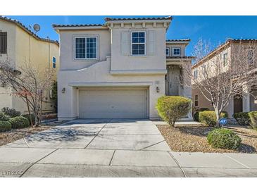 Charming two-story home featuring a two-car garage, landscaped front yard, and inviting curb appeal at 10997 Sardinia Sands Dr, Las Vegas, NV 89141