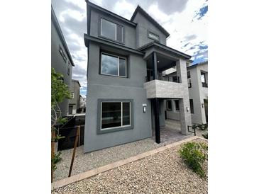 Modern two-story home featuring a stucco exterior, covered porch, and gravel landscaping at 1433 Nocturnal Flight St, Las Vegas, NV 89138