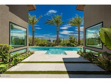 Luxury pool with palm trees and modern architecture at 818 Meyer May St, Las Vegas, NV 89138