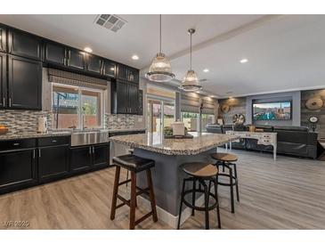 Spacious kitchen with island, stainless steel appliances, and granite countertops at 10529 Parthenon St, Las Vegas, NV 89183