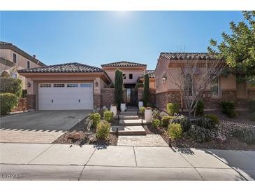 Single-story home with stone accents and landscaped front yard at 2261 Boutique Ave, Henderson, NV 89044