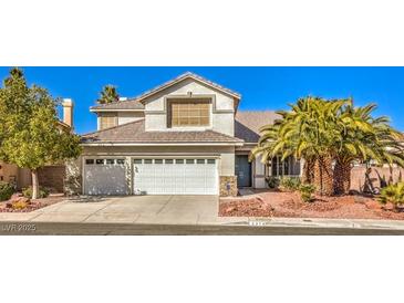 Two-story house with a white double garage and landscaping at 2374 Thayer Ave, Henderson, NV 89074