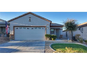 Single-story house with a two-car garage and landscaped front yard at 2575 Red Planet St, Henderson, NV 89044