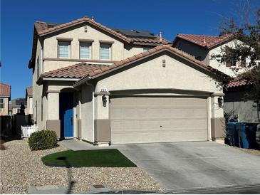 Two-story house with beige exterior, solar panels and a two-car garage at 264 Bella Matese Ave, Las Vegas, NV 89183