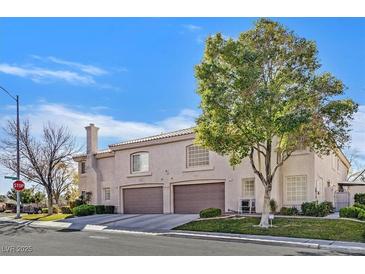 Two-story townhome with a two-car garage and landscaped front yard at 513 Rafkin Pl, Henderson, NV 89052