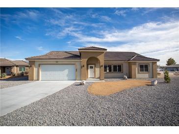 Charming single story home with a low maintenance desert rock yard and covered front porch at 521 Antelope Ave, Pahrump, NV 89060