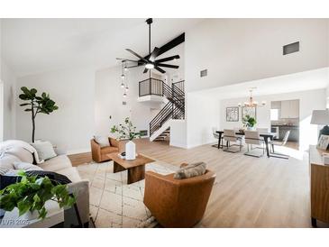 Bright living room featuring hardwood floors, vaulted ceilings and a cozy seating area at 602 Calcutta Ln, Henderson, NV 89015