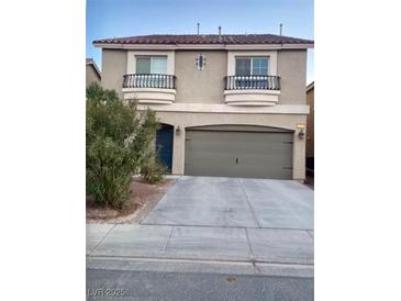 Two-story house with attached garage and balconies at 6059 Thistle Meadow Ave, Las Vegas, NV 89139