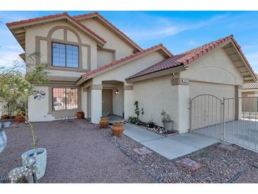 Two-story house with Spanish tile roof, landscaped yard, and attached two-car garage at 6233 Morning Splendor Way, Las Vegas, NV 89110