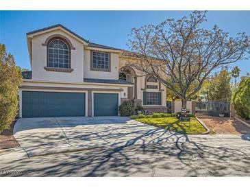 Two-story house with a landscaped yard, two-car garage, and gated entry at 6901 Copper Kettle Ave, Las Vegas, NV 89130