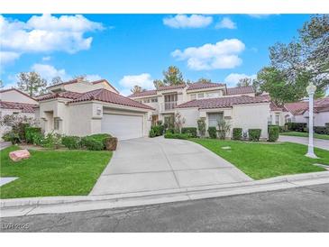 Two-story house with tile roof, attached garage, and landscaped yard at 6948 Emerald Springs Ln, Las Vegas, NV 89113