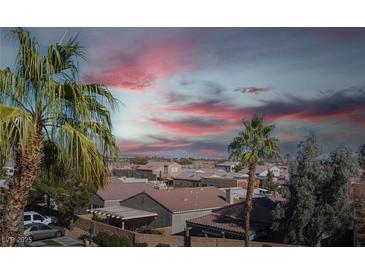 Community view with sunset, palm trees, and houses at 79 E Agate Ave # 306, Las Vegas, NV 89123