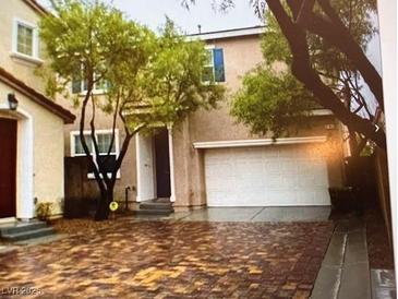 Two-story house with a brick driveway and attached garage at 8384 Creek Canyon Ave, Las Vegas, NV 89113