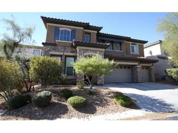 Two-story house with stone accents and landscaped yard at 8719 Mount Mira Loma Ave, Las Vegas, NV 89178