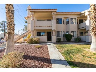 Two-story condo building with a walkway and landscaping at 1005 Sulphur Springs Ln # 202, Las Vegas, NV 89128