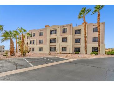 Two-story building exterior with parking and desert landscaping at 2072 Mesquite Ln # 104, Laughlin, NV 89029