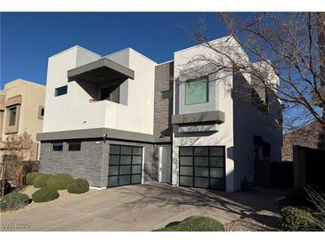 Modern two-story home with attached two-car garage and landscaped front yard at 232 Errogie St, Henderson, NV 89012