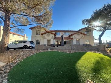 Two-story house with a landscaped yard and a car parked in front at 3484 Twilight Star Dr, Las Vegas, NV 89117