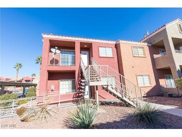 Two-story stucco building with stairs and desert landscaping at 4730 E Craig Rd # 2028, Las Vegas, NV 89115