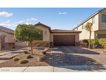 Single-story home with a two-car garage and well-manicured landscaping at 6333 Supernova Hill St, North Las Vegas, NV 89031