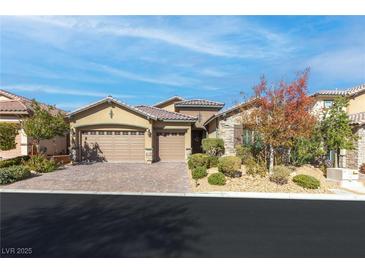 Two-story house with a three-car garage and landscaped front yard at 7576 Windy Meadow Ave, Las Vegas, NV 89178