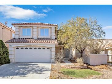 Two-story house with a two-car garage and landscaped yard at 7645 Rustic Galleon St, Las Vegas, NV 89139