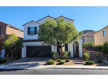 Two-story house with dark brown garage door and landscaped front yard at 9545 Belmont Bay Ave, Las Vegas, NV 89148