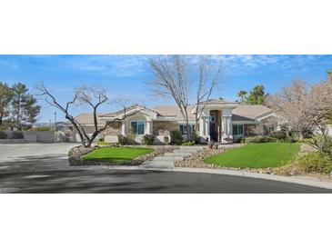 Single-story house with stone accents and landscaped yard at 10032 Fox Springs Dr, Las Vegas, NV 89117