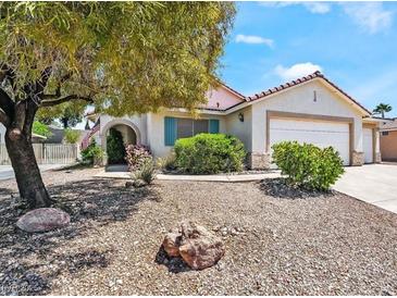 Charming single-story home featuring desert landscaping, a three car garage and mature shade trees at 1060 Gallant Fox Ave, Henderson, NV 89015