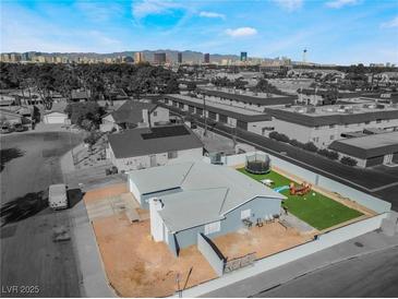 Charming home with a well-kept lawn and a view of the city skyline at 2690 Diamante Cir, Las Vegas, NV 89121