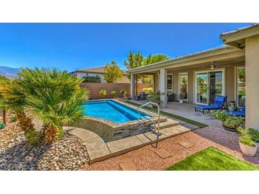 Inviting backyard oasis featuring a modern pool and spacious patio at 4884 E Cactus Canyon Dr, Pahrump, NV 89061