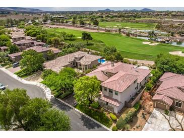 Stunning aerial view of a luxury home with a pool overlooking a lush green golf course in a beautiful neighborhood at 5 Clear Crossing Trl, Henderson, NV 89052