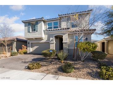 Two-story house with gray siding, landscaping, and a three-car garage at 7220 Piute Mesa St, North Las Vegas, NV 89084