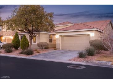 Beautiful two-story house with landscaped yard, attached garage, and inviting curb appeal at 7620 Chase Hallow St, Las Vegas, NV 89149