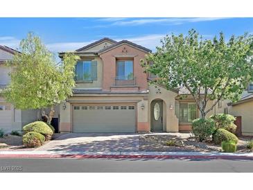 Two-story house with a green door and attached garage,landscaped yard at 8212 Opal Falls St, North Las Vegas, NV 89085