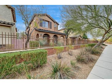 Two-story house with front yard landscaping and a brown fence at 10079 S Riley St, Las Vegas, NV 89178