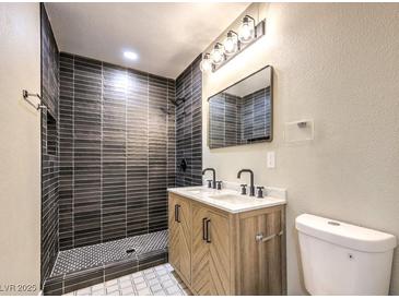 Modern bathroom with dark tile shower and double vanity at 104 Temple Dr, Las Vegas, NV 89107